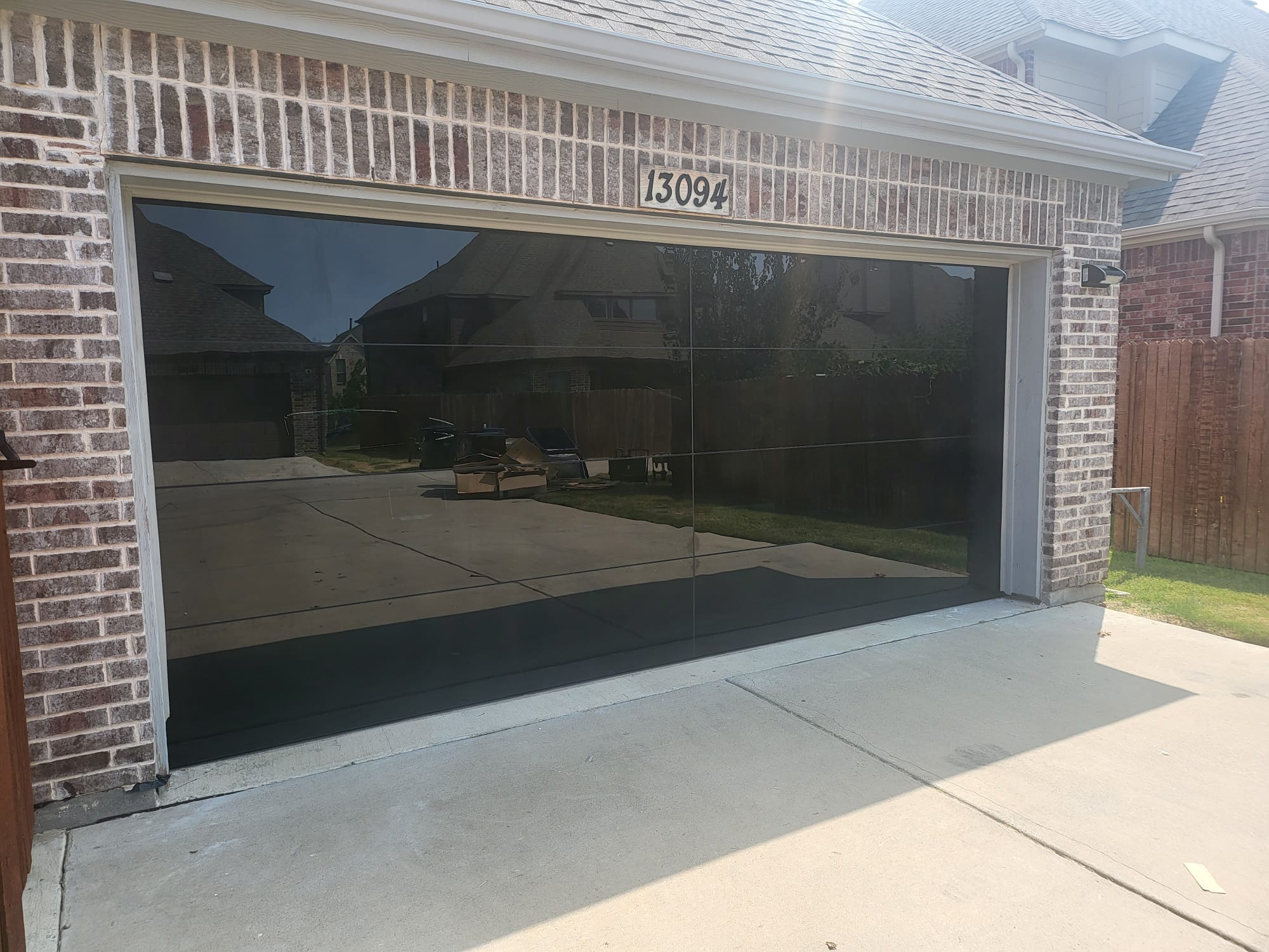 16 by 8 Full View Frameless Garage Door With Black Tinted Tempered Glass